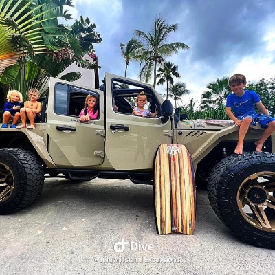 Kids sitting on a jeep